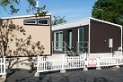 Two abandoned tiny homes sit in a BART parking lot. Their owner owes the agency over $150,000