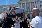 Transit activists carry BART, Muni ‘trains’ in caskets to San Francisco City Hall